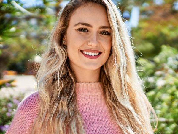 Smiling woman with long blonde hair outdoors